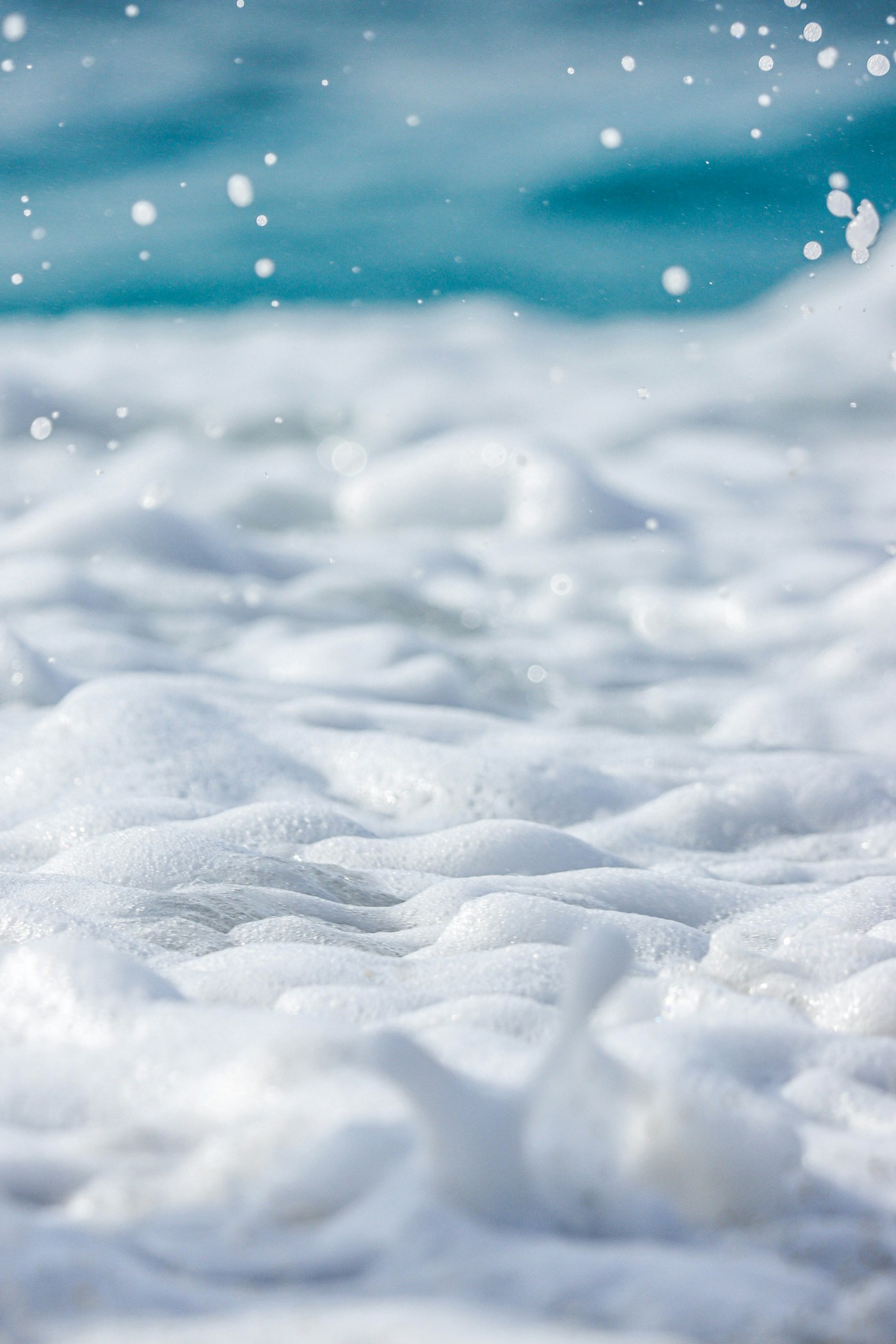 Soft ocean foam and blue water