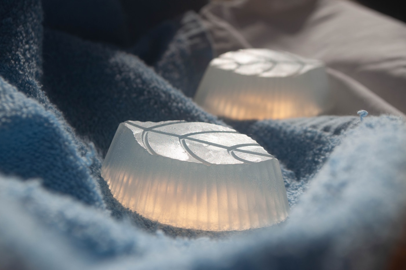Leaf-shaped soaps on a soft towel