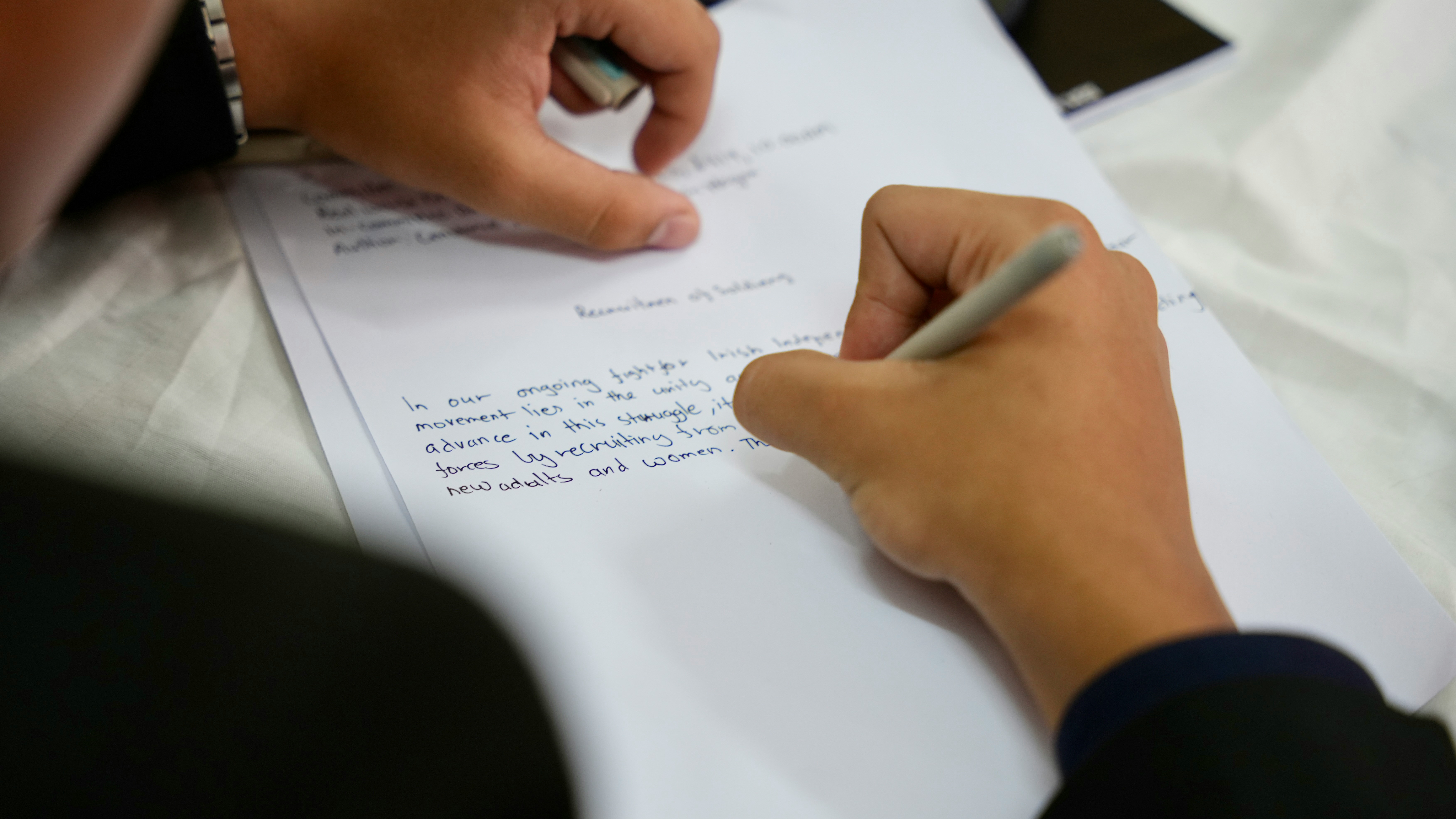 Person writing notes on paper